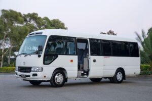 Comfortable commuter bus ready for rental, part of our bus for rent services in Sharjah, parked in an urban setting.